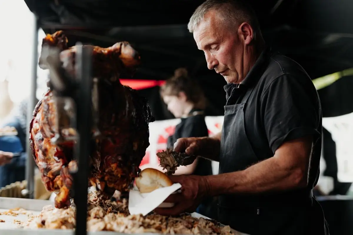 The owner of the business serving a pig roast bap